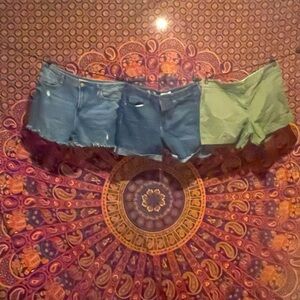 2 pairs of Jean shorts and a pair of green cotton shorts.